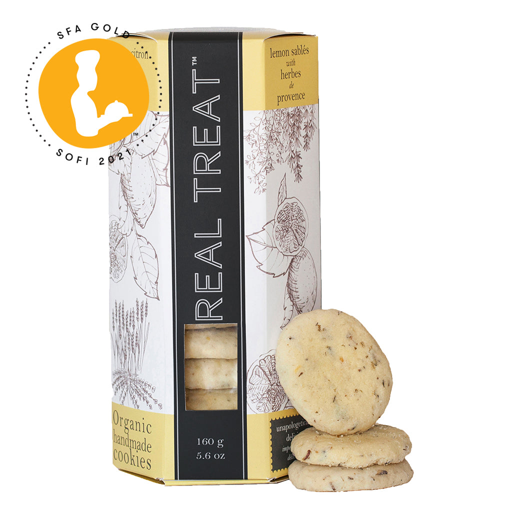 A single package of SOFI Award-winning Lemon Sablés with Herbes de Provence with a stack of 3 cookies